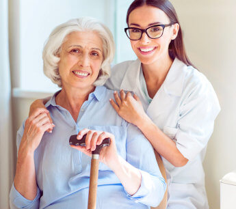 caregiver and elderly woman smiling