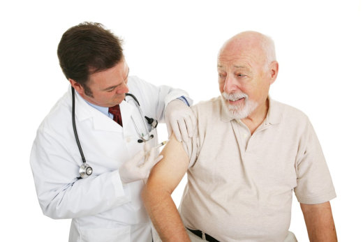 A doctor is giving an older man the flu shot.